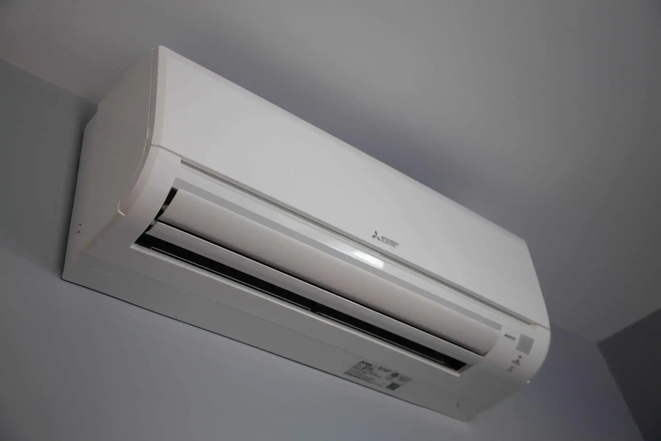 Wall-mounted ductless mini-split head cooling a room in an older Whitewright, TX home