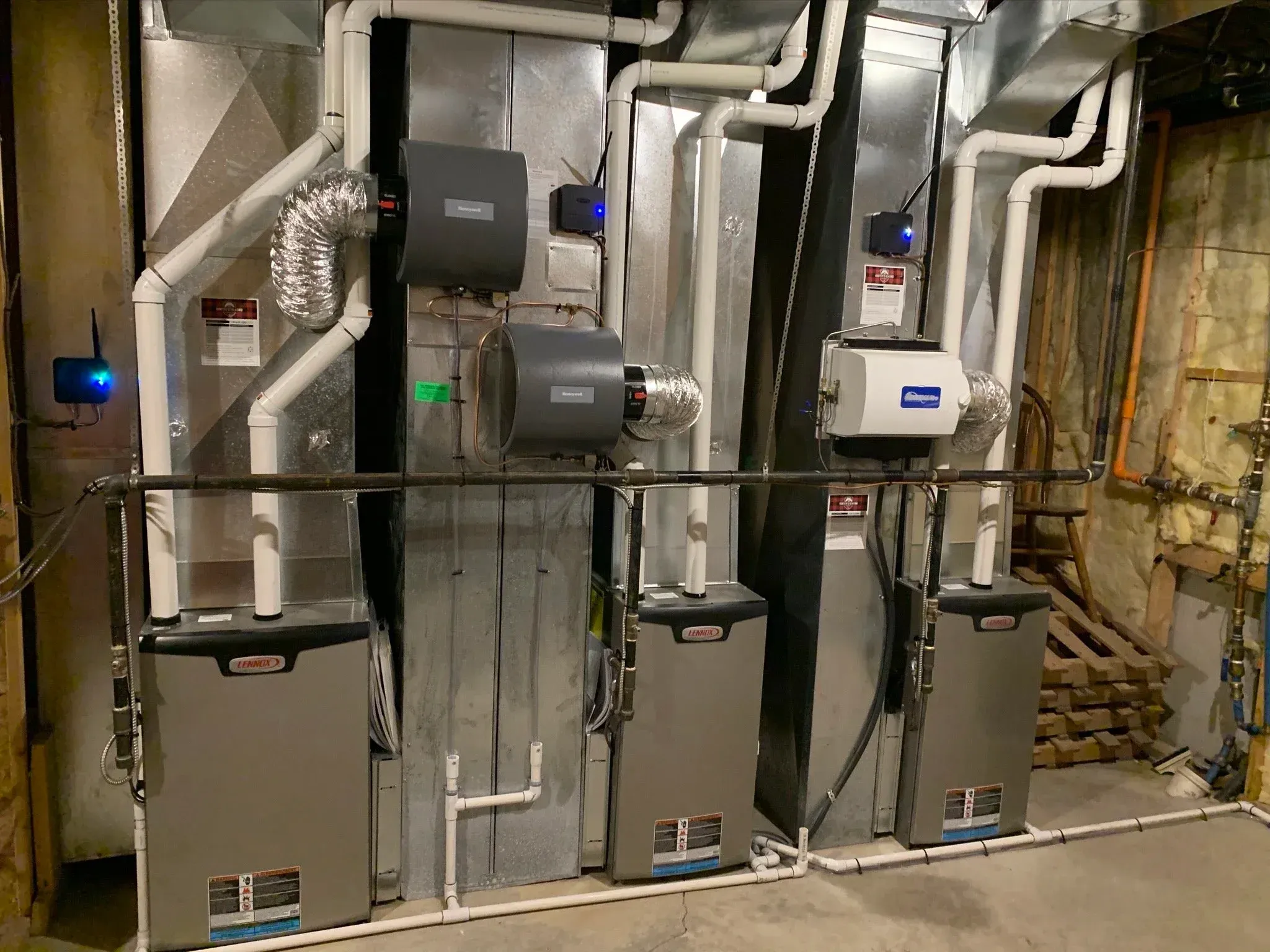 Three high-efficiency furnaces installed side by side in the mechanical room of a large Prosper, TX home